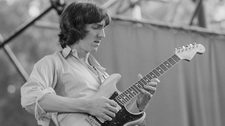 Allan Holdsworth playing guitar on stage