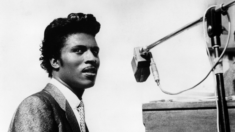 Little Richard with piano and microphone