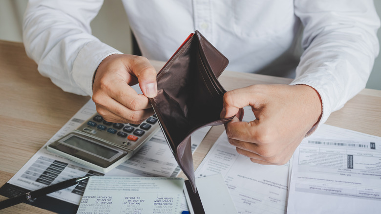 man opening empty wallet