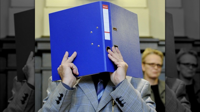 Josef Fritzl hiding face in book