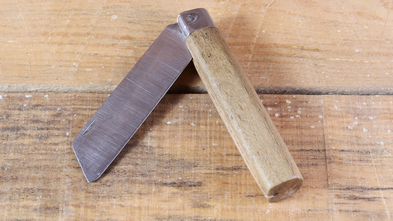 clasp knife on wooden desk