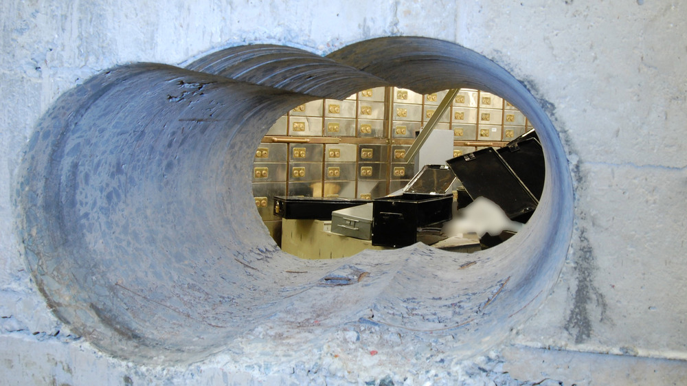 Worker peering through robbery hole