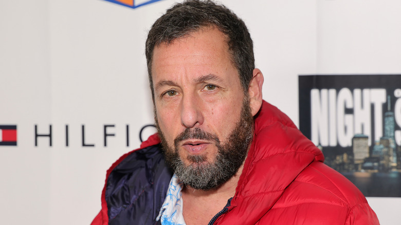 Adam Sandler looking at camera suspiciously