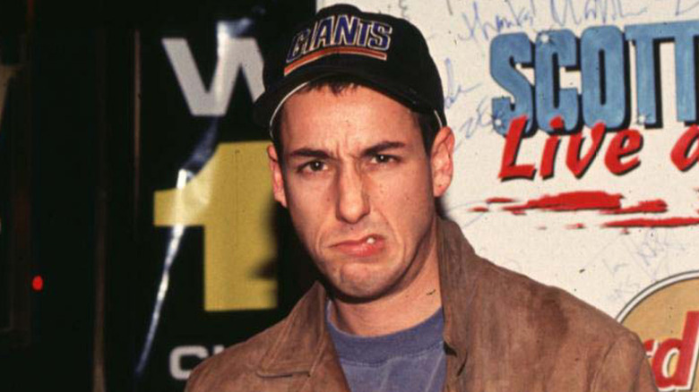 Adam Sandler in baseball cap making silly face
