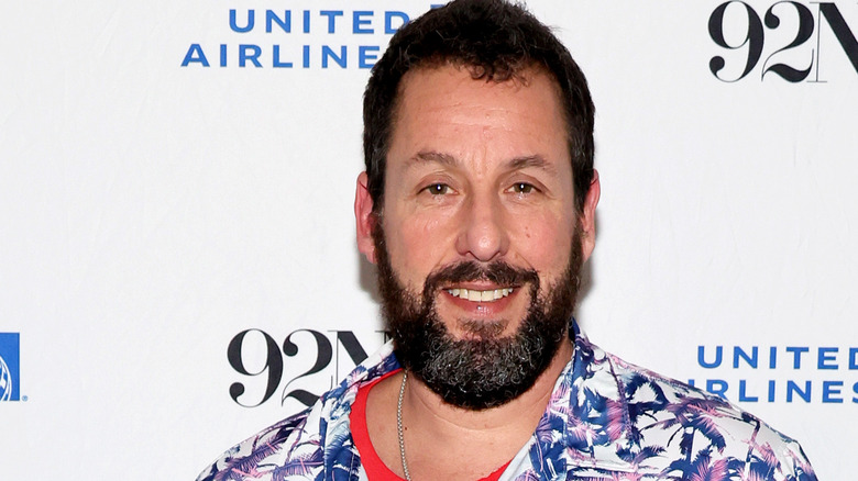 Adam Sandler smiling into camera