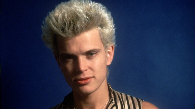 billy idol leering into camera wearing striped vest