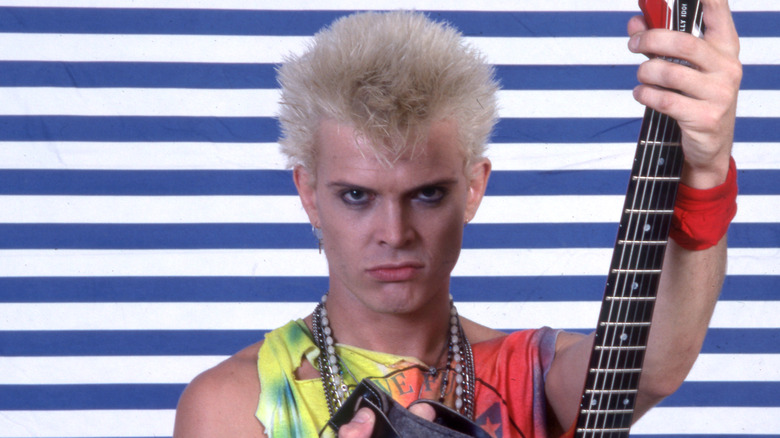 billy idol holding guitar and wearing tie-dye tank top