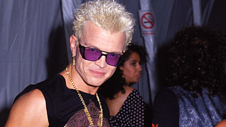 billy idol in purple sunglasses smiling at camera