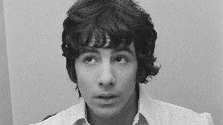 Young Cat Stevens in white shirt looking up