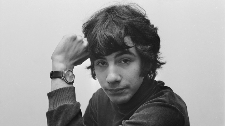 Young Cat Stevens wearing watch hand on head turtleneck sweater white background