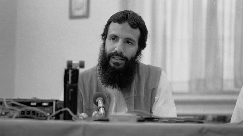 Cat Stevens long beard sat talking at press conference