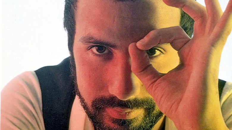 Cat Stevens with goatee pinching fingers around left eye