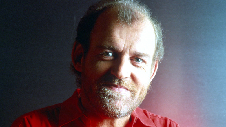 Joe Cocker grinning in red shirt