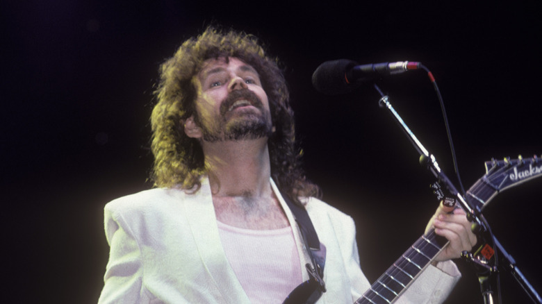 brad delp of boston performs in white suit in 1980s