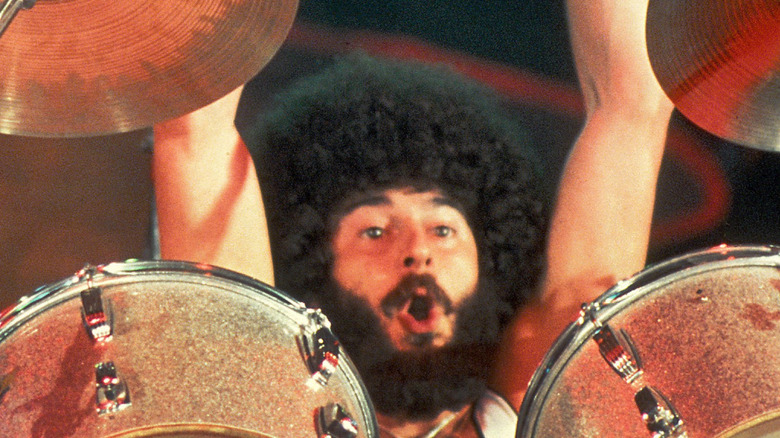 sib hashian throwing up arms while playing drums with boston