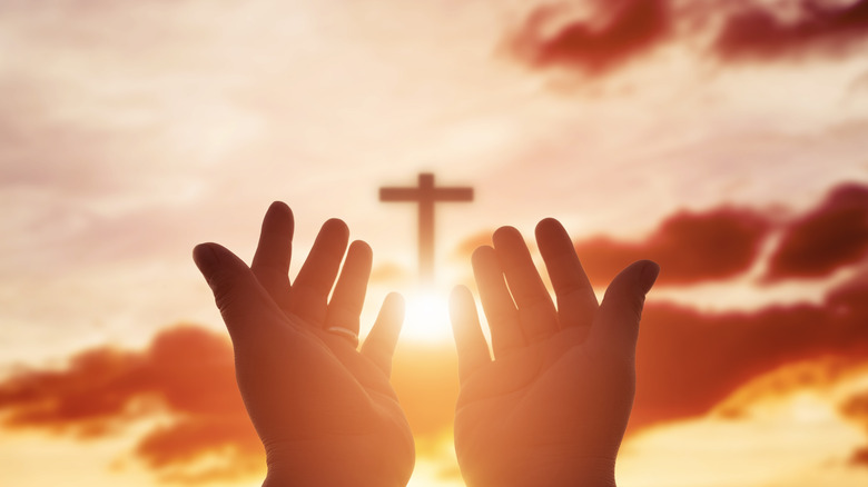 open palms with Bible in them