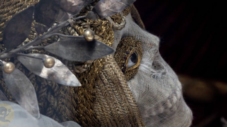 jeweled skeleton face with embellishments around the eye