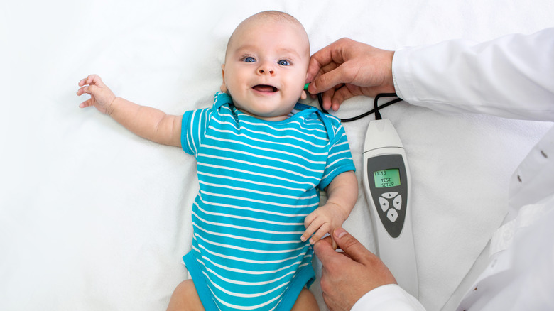 Baby getting a hearing screening including Otoacoustic Emissions