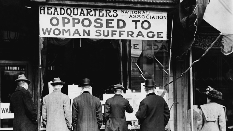 Men view anti-suffrage booth