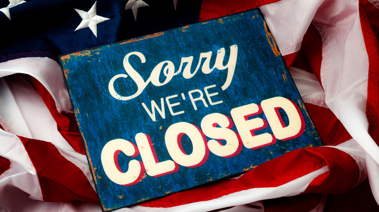 American flag we're closed sign
