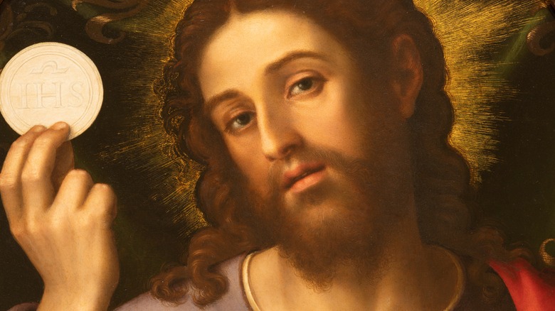 Jesus holding a communion wafer