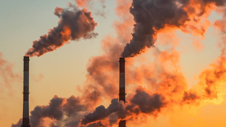 Smokestacks against an orange sky 