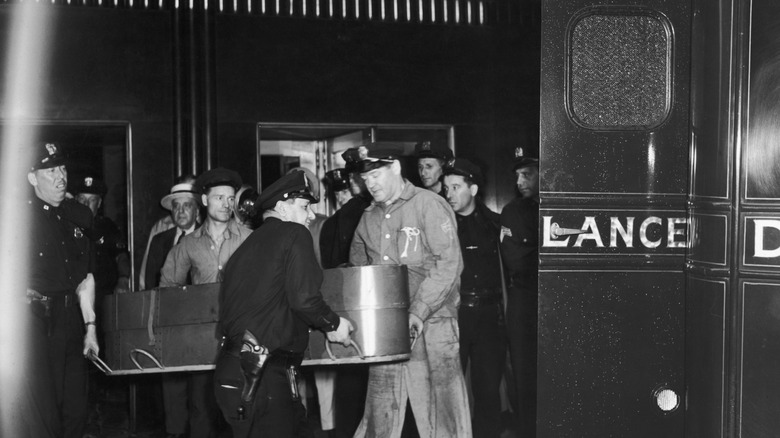 Men carrying a coffin from the Empire State Building into an ambulance