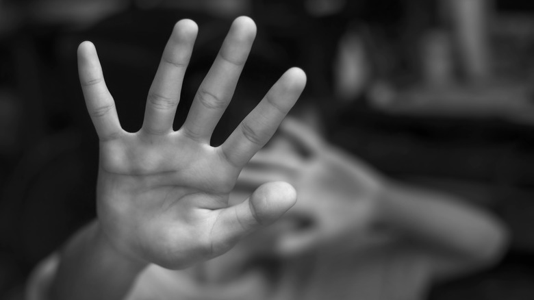 Child holding up protective hand