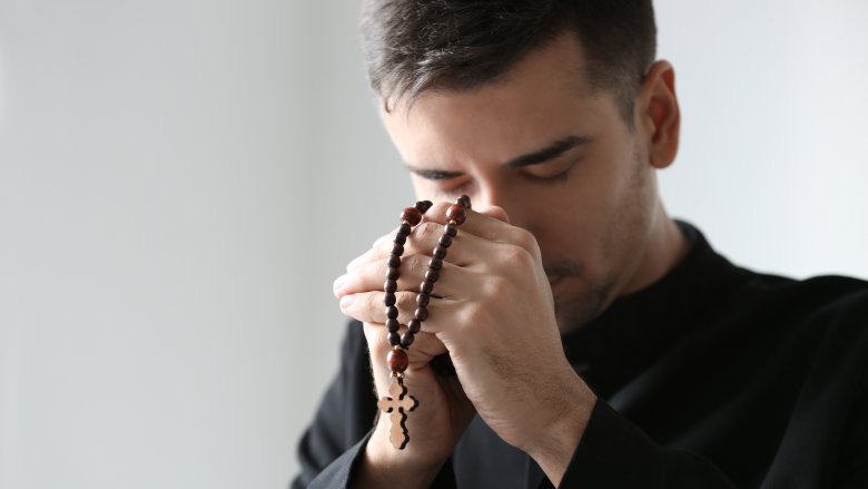 catholic priest praying