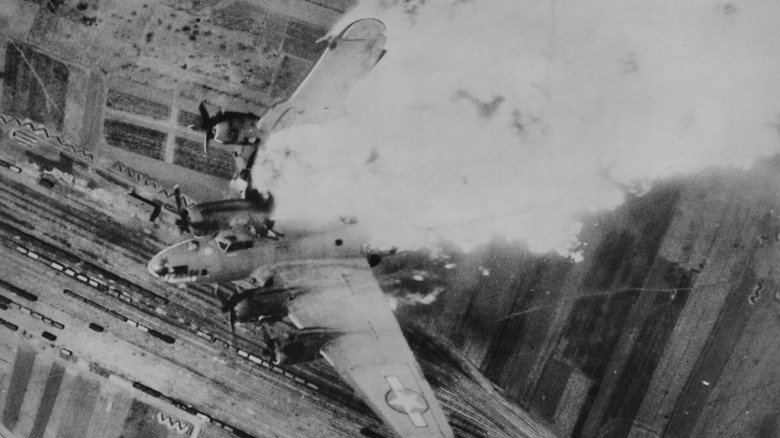 A Boeing B-17F Flying Fortress nicknamed Whizzer II takes major damage after flak fire, 1944
