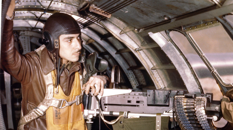 Technical Sergeant Mexico Barraza, gunner and radio operator, in position at the waist gun of a B-17