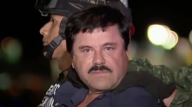 El Chapo with military guards staring at camera