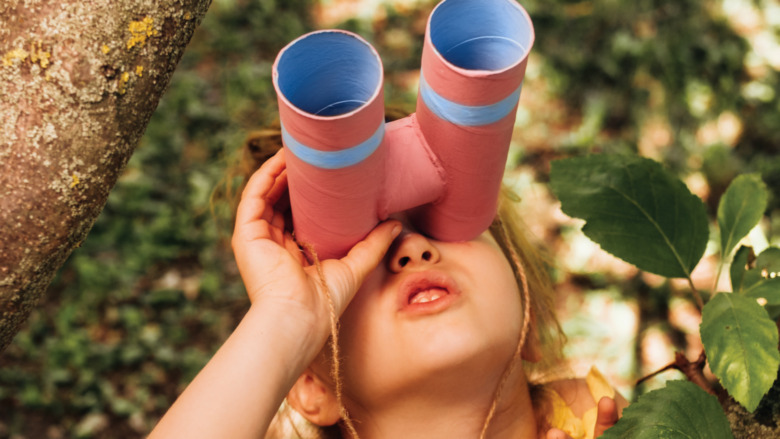 Little girl using binoculars