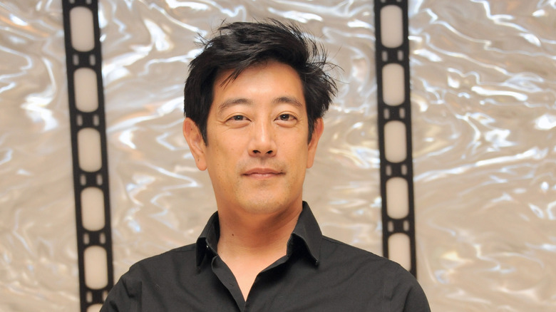 Grant Imahara posing in black shirt