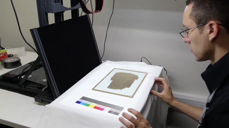 scientist photographing Beatty papyrus