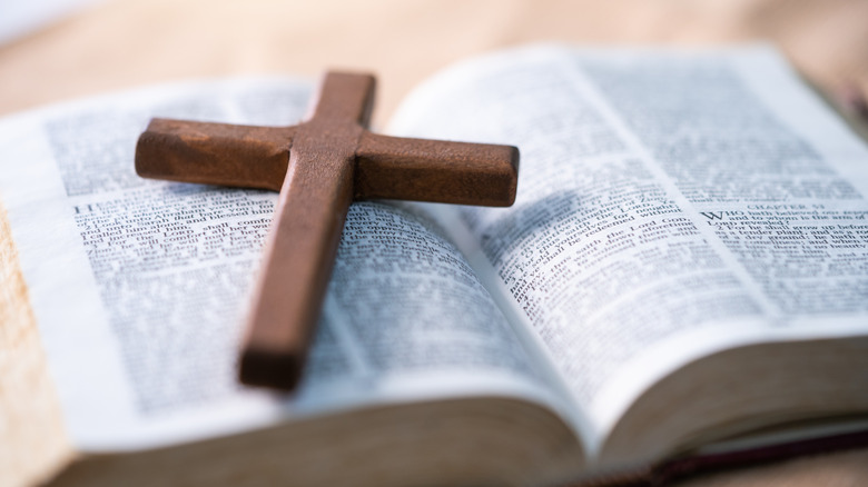 Simple wooden cross on Bible