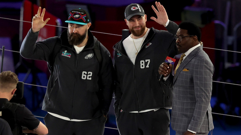 Jason and Travis Kelce wave onstage