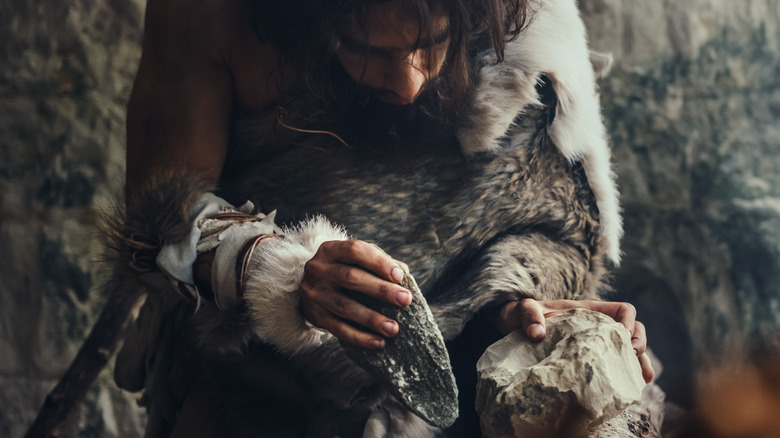 Stone age man with tools