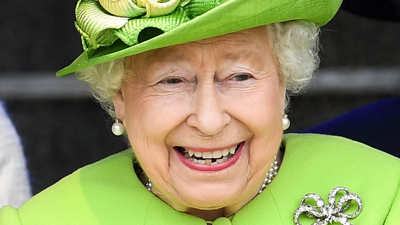 Queen Elizabeth II laughing at an event with Meghan Markle