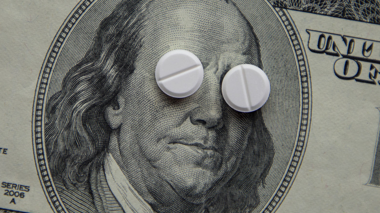 pharmaceutical drugs over a 100 dollar bill