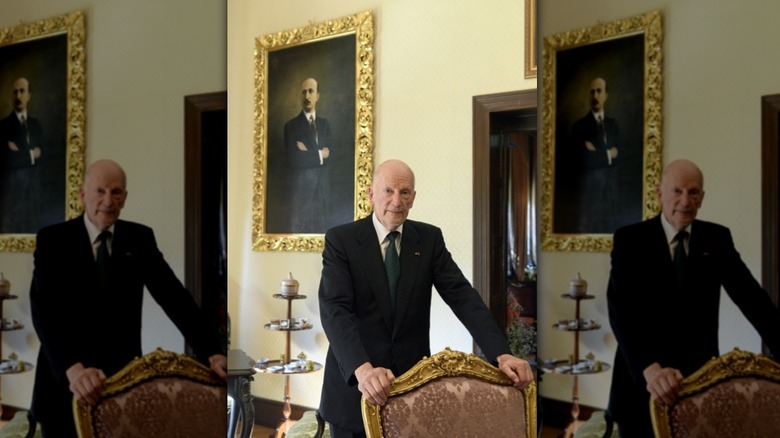 Simeon of Bulgaria stands behind chair