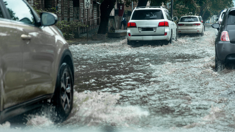 Cars driving through floodwaters