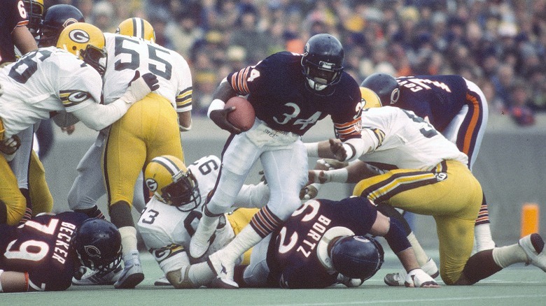 Walter Payton carrying football