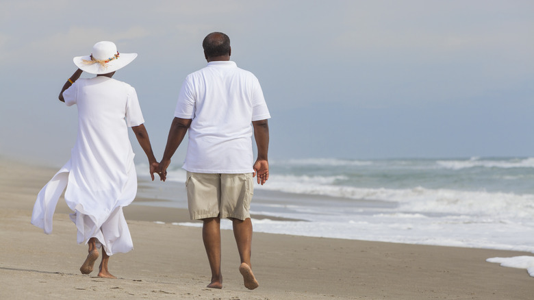Elderly couple walking on the beach
