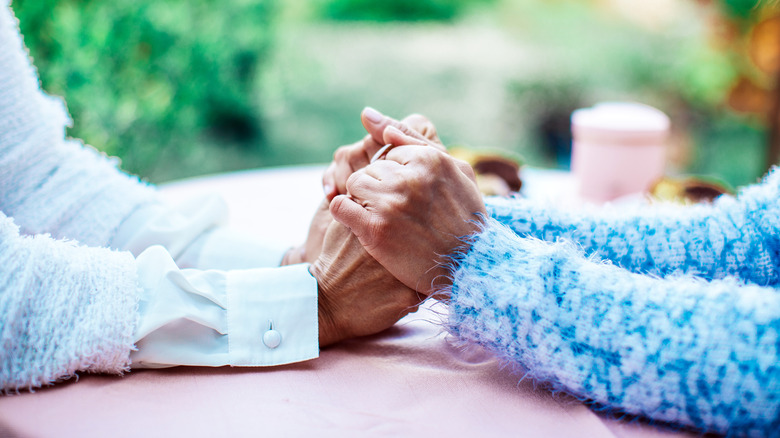 Older couple holding hands