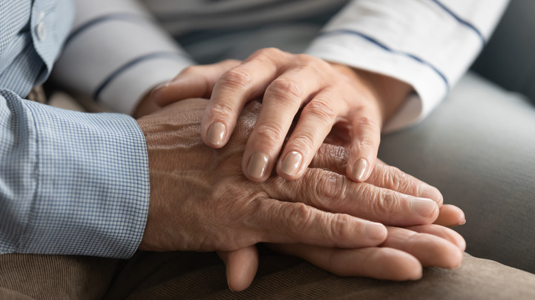 old couple holding hands 