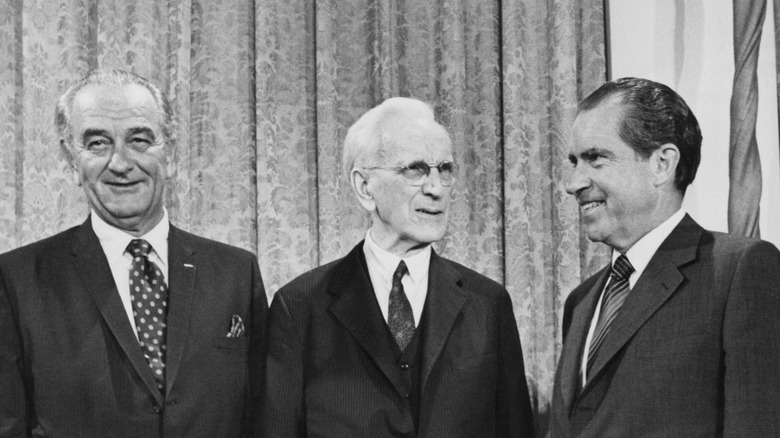 John W McCormack standing between presidents Lyndon Johnson and Nixon smiling