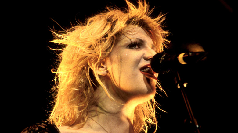 Courtney Love onstage with microphone