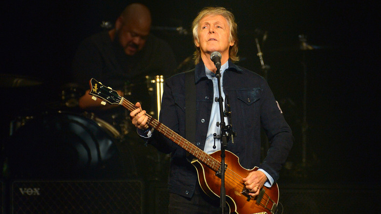 Paul McCartney performing live with bass guitar