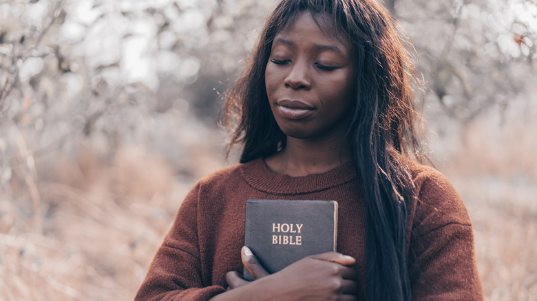 a woman holding a bible